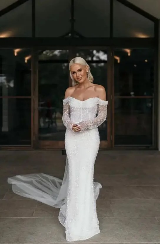 a modern mermaid fully embellished off the shoulder wedding dress with a long train will bring a touch of sparkle