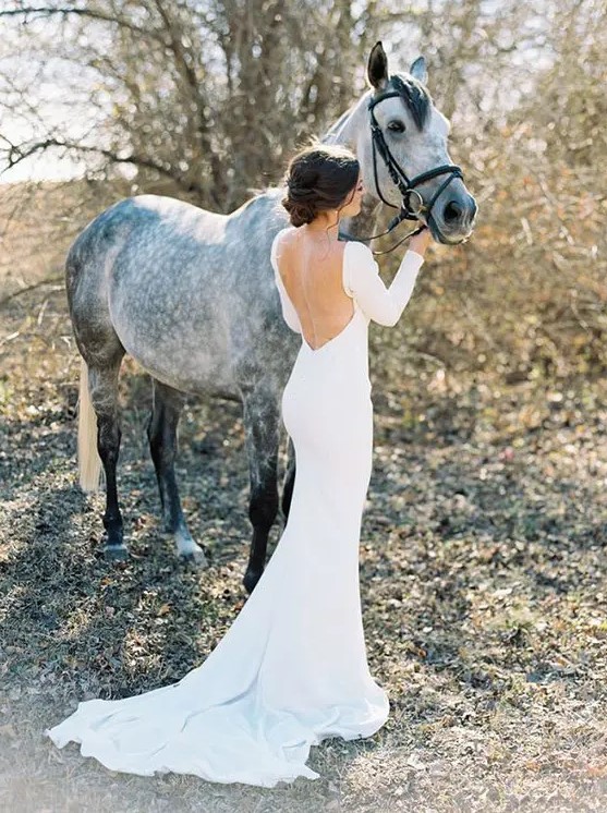 a modern sexy mermaid plain wedding dress with a low back, long sleeves and a train is a refined and gorgeous idea to rock