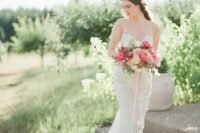 a romantic lace mermaid wedding dress with an illusion strapless neckline and a train for a chic and very feminine look