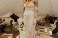 a strapless blush heavily embellished mermaid wedding dress with a train will make a bold statement