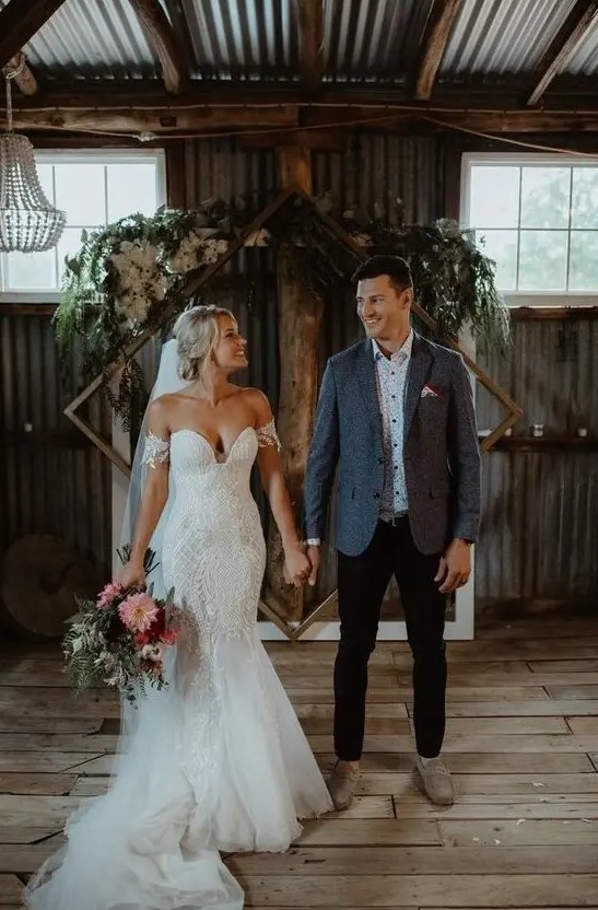 a super sexy off the shoulder boho lace mermaid wedding dress with a train and a veil is gorgeous