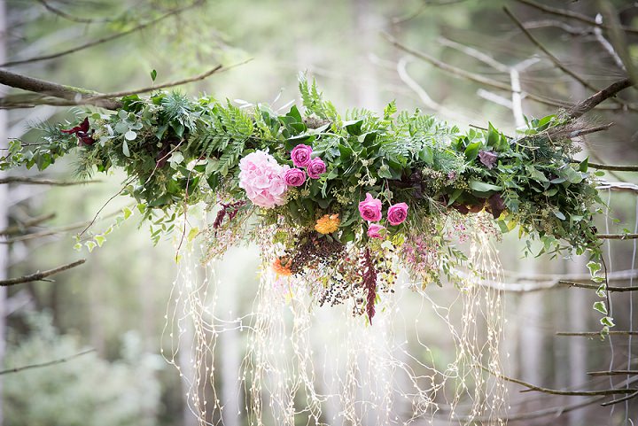 Lush floral chandeliers and decor with vibrant colors were created by the stylists