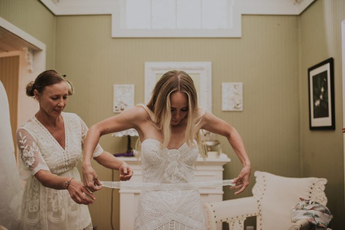 The bride opted for a gorgeous boho lace strapless wedding dress by Rue de Seine