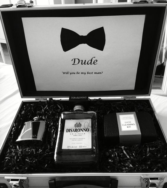 a stylish black and white box with a flask, some alcohol and a shoe cleaning kit