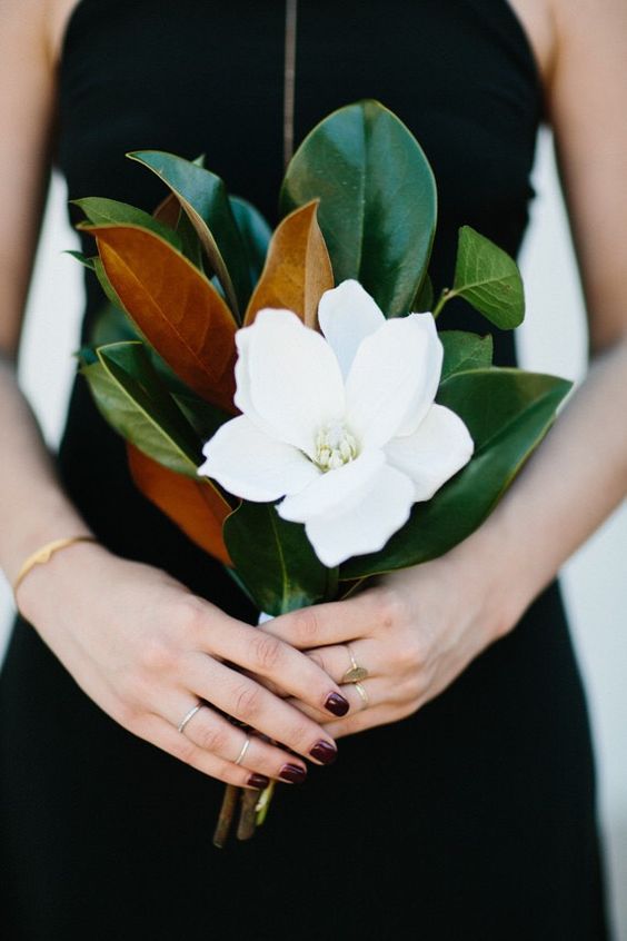 a magnolia leaf and single bloom bouquet is an elegant option for a bridesmaid