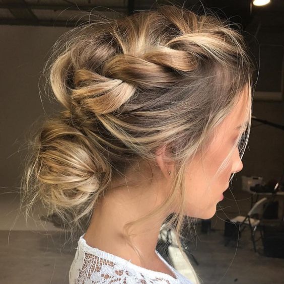 a messy braided low bun updo for a modern and trendy look