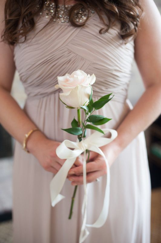 single stem bouquets are perfect for bridesmaids, like this white rose with a ribbon bow