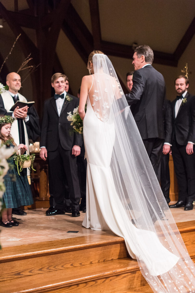 The back of the dress was an illusion one, and the bride chose a proper long veil