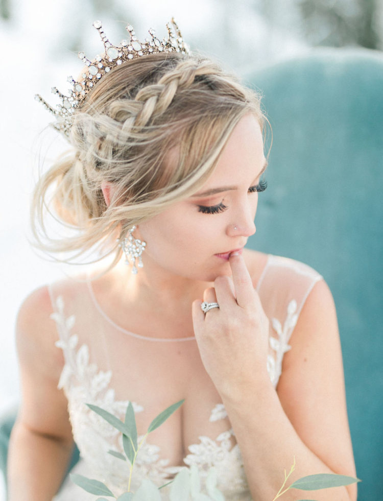 The bride was wearing a gorgeous sparkling crown and statement earrings for a chic look, her braided updo was very romantic