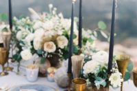 04 a moody spring table setting with slate blue candles, brass glasses and goblets, stone-inspired plates and marbeleized candle holders