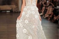 04 embellished wedding dress with shimmering beadwork, a covered plunging neckline and 3D floral appliqués