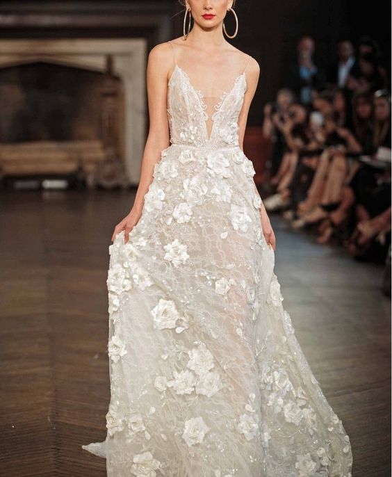 embellished wedding dress with shimmering beadwork, a covered plunging neckline and 3D floral appliqués
