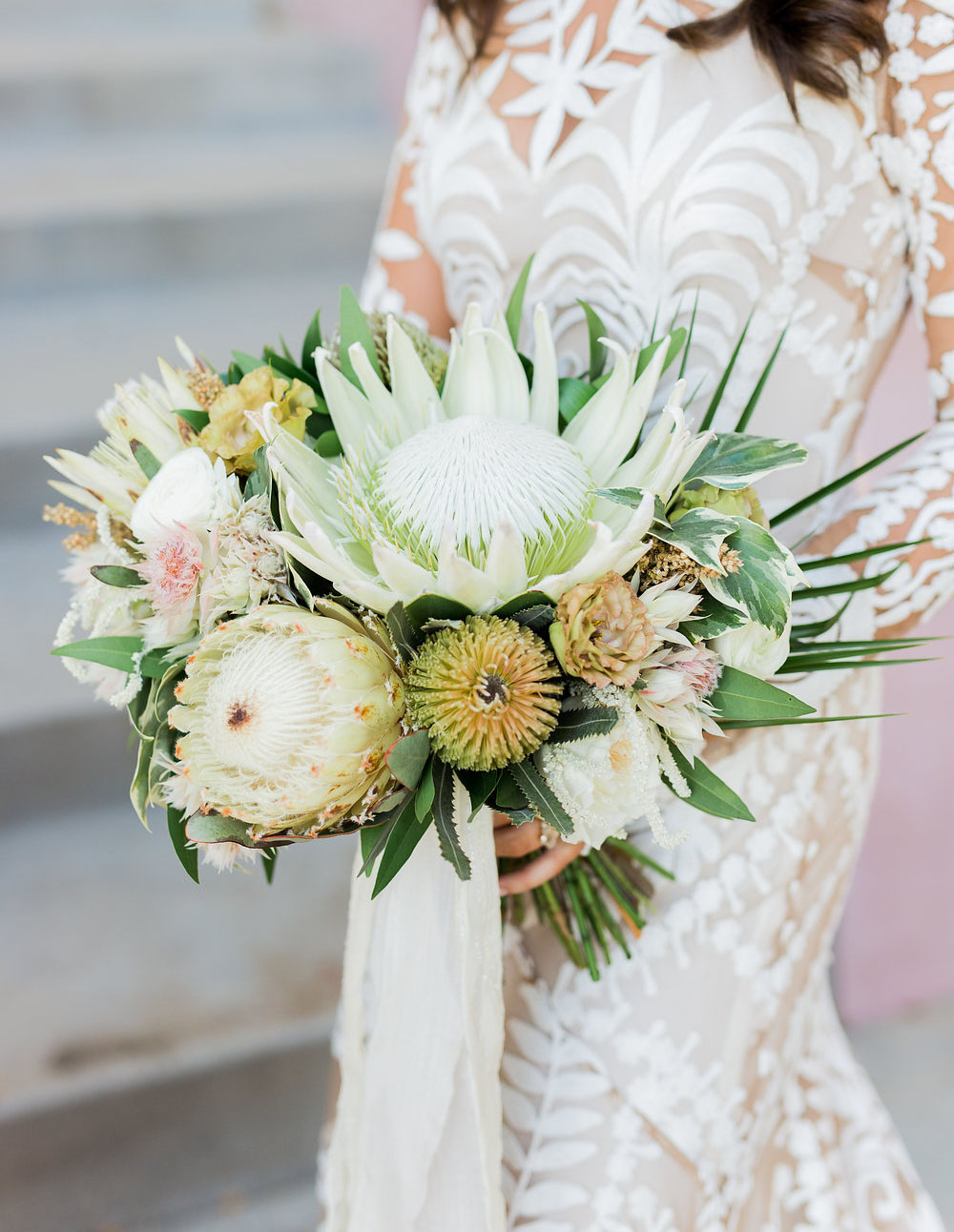 The bridal bouquet was done with king proteas, greenery and astilbe