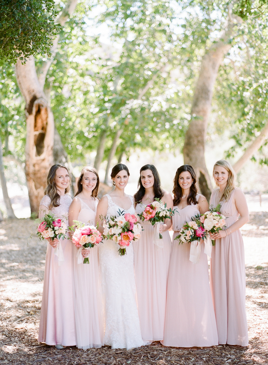 The bridesmaids were wearing mismatched blush gowns