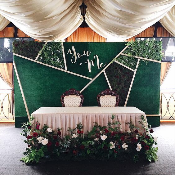 a modern geometric backdrop with fresh moss, foliage, calligraphy and matching fabric