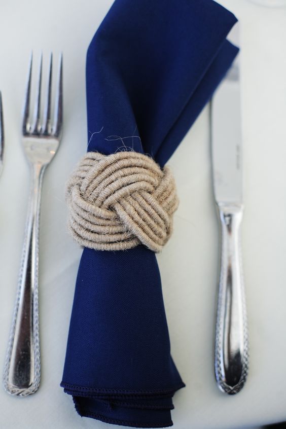 a navy napkin with a twine kot napkin ring for a nautical wedding