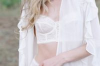 06 a short modern bridal robe with long ruffled sleeves over white lace bridal lingerie for a couple of boudoir shots