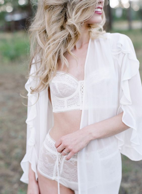 a short modern bridal robe with long ruffled sleeves over white lace bridal lingerie for a couple of boudoir shots