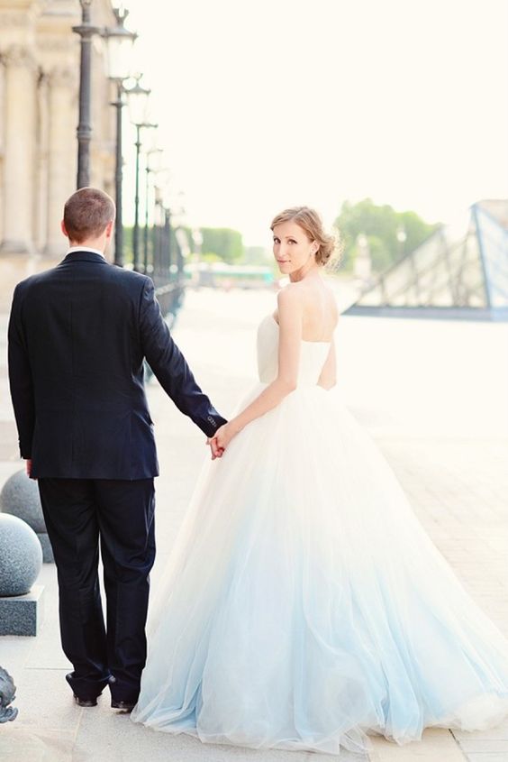 a strapless ballgown-style wedding dress with an ombre blue skirt for something blue at your wedding