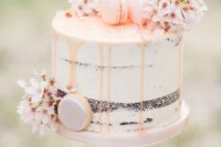 07 a semi naked wedding cake with blush drip, cherry blossom and blush macarons
