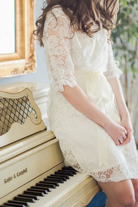 a short off-white lace bridal robe with half sleeves and a silk sash will fit many brides