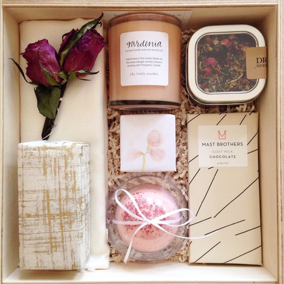 a chic box with dried flowers, some spa soap, a candle, dried petals and chocolate