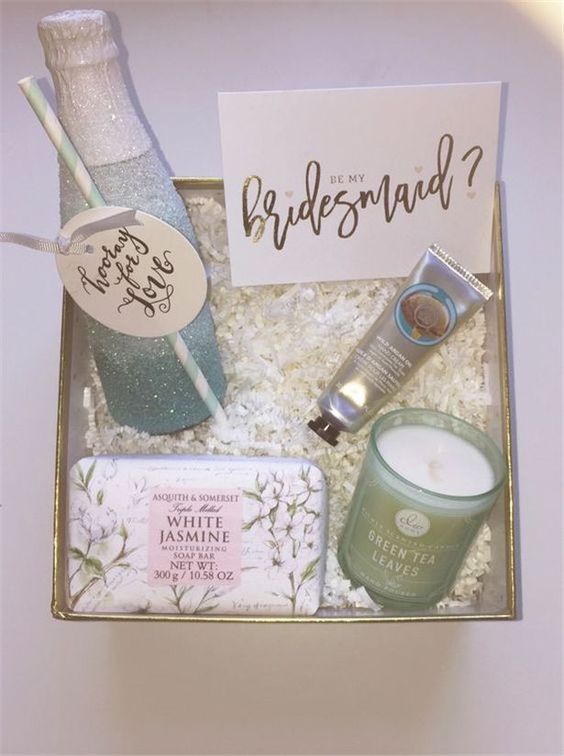 a gorgeous spa box with a candle, a soap, a lotion and a bottle of champagne