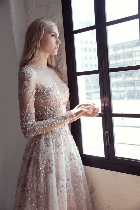 a silver floral appliques and embbroidery wedding dress with illusion sleeves and a bodice