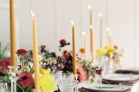 10 yellow candles and moody florals plus refined chargers make this spring table settign moody