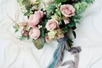 11 a beautiful bouquet with dusty pink blooms, eucalyptus and dark leaves