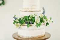 11 a semi-naked wedding cake with fresh foliage, blooms and blues for a fresh spring look