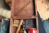 11 a stained wooden box with a cigar, Jack Daniel’s, Coca Cola and a cigar cutter