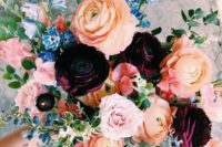 12 a bold and colorful bouquet in peachy orange, blue and pink is made more moody with deep purple blooms