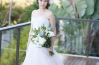 12 a strapless sweetheart neckline princess-style wedding dress with a ruffled ombre pink skirt