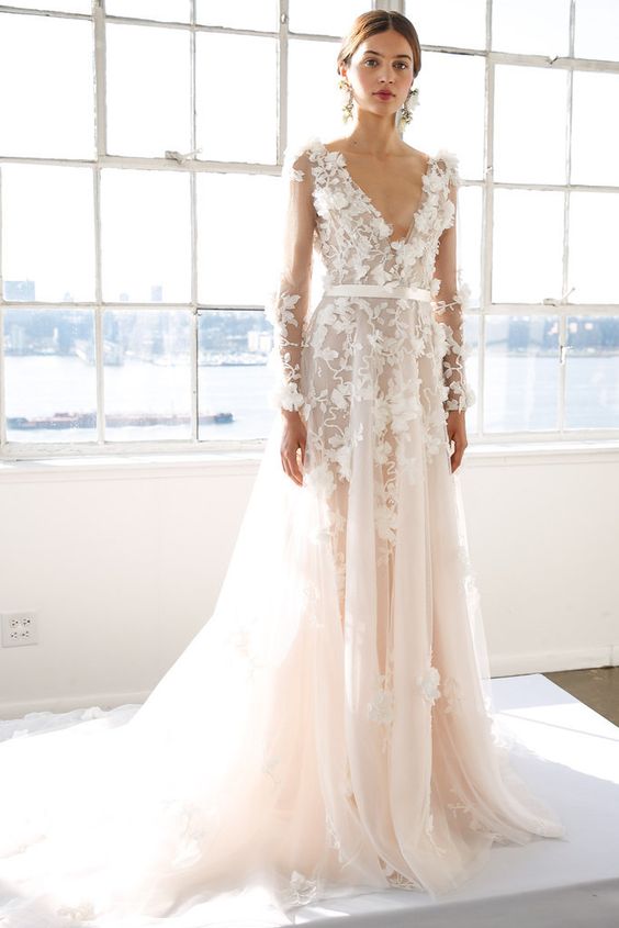 an off-white floral applique wedding dress with long sleeves and a deep V-neckline