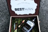 13 a box with moss, a cigar, a small bottle of alcohol and a knife for a stylish woodland proposal