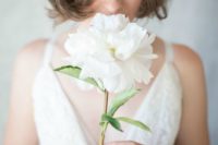 13 a single white peony for a casual and chic bridal style