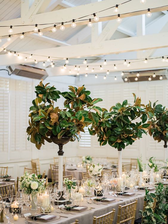refined manolia leaf centerpieces on tall stands won't take much space but look wow