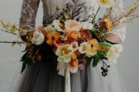 14 a moody wedding bouquet with orange and yellow splashes and an interesting texture