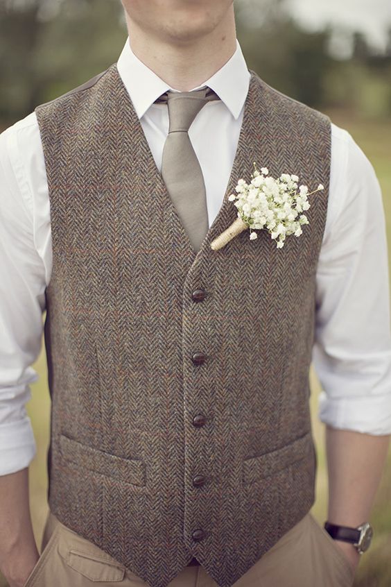 tan pants, a white shirt, a grey tie and a brown waistcoat