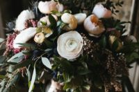 15 a wedding bouquet of blush and white blooms and blue thistles
