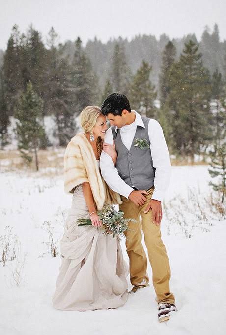 tan pants, a grey vest, a white shirt and boots for a relaxed winter groom's look