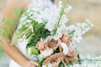 16 a wedding bouquet with white and dusty pink blooms and greenery looks pastel yet moody