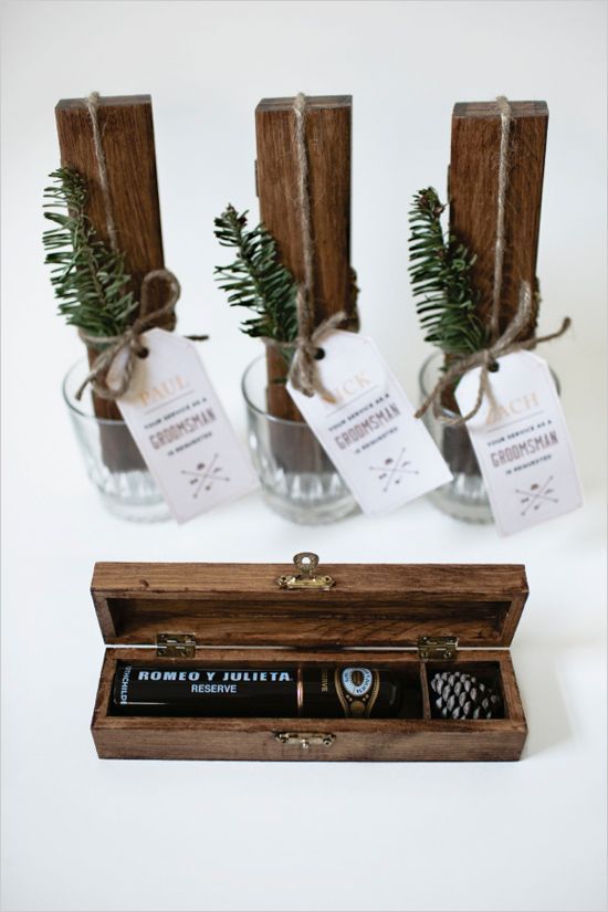 a wooden box with a little pinecone and a cigar for a stylish winter wedding