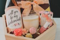 17 a cute bridesmaid’s box with a candle , a soap, some chocolate and pops, a bottle of wine and nail polish