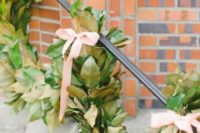 17 a lush magnolia garland with ribbon bows for staircase decor
