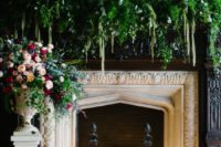 19 an exquisite fireplace with lush greenery and florals plus lots of candles as a ceremony space