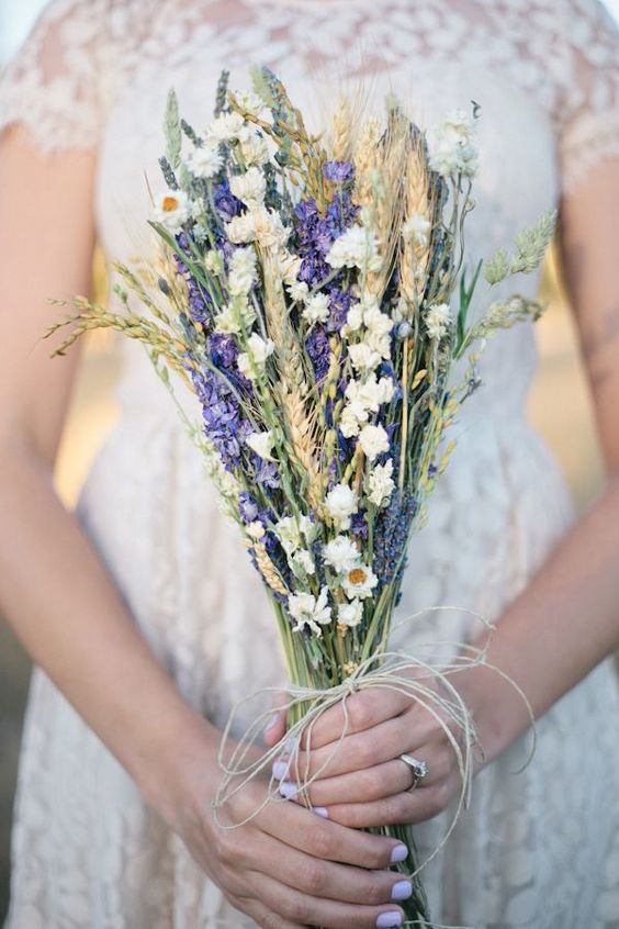 a cool rustic bouquet with wheat, purple delphinium, some dried white blooms