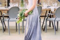 20 a sleeveless lace applique wedding dress with a V-neckline and a slate grey ombre skirt