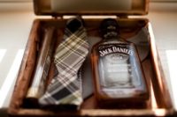 20 a small box with a cigar, a checked tie and Jack Daniel’s for a simple and stylish proposal